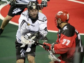 Rush's Ryan Dilks clashes with Roughnecks Jeff Shattler during Friday's game in Calgary. (Mike Drew, QMI Agency)
