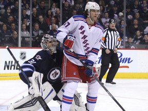 Winnipeg Jets goaltender Ondrej Pavelec is lost behind New York Rangers forward Brian Boyle on a power play during NHL action at MTS Centre in Winnipeg, Man., on Fri., March 14, 2014. Kevin King/Winnipeg Sun/QMI Agency