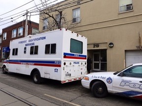 Toronto Police vehicles parked outside a building at 219 Broadview Ave. where a man was killed on March 15, 2014. (Dave Abel/Toronto Sun)