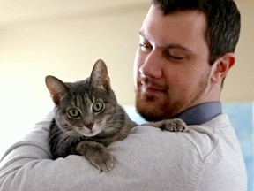 Jared Havelock holds his sister Maddie's cat "Boo" at the family home in Barrhaven. Maddie was killed in a car accident on March 28, 2013 on her way home for Easter. Maddie was an avid animal lover and money is being raised to honour her memory at the Ottawa Humaine Society. March 15, 2014. 
Errol McGihon/Ottawa Sun/QMI Agency