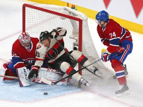 Ottawa Senators right wing Ales Hemsky (83) crashes into Montreal Canadiens goalie Carey Price (31) as defenseman Alexei Emelin (74) defends during the first period at Bell Centre. Mandatory Credit: Jean-Yves Ahern-USA TODAY Sports