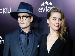 Cast member Amber Heard and her fiance, actor Johnny Depp, pose at the premiere of "3 Days to Kill" in Los Angeles, California February 12, 2014. The movie opens in the U.S. on February 21. REUTERS/Mario Anzuoni