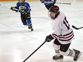 Bantam Hawk Brayden Stokes skates the puck out of his team’s zone Saturday at the Vulcan District Arena during second period action in the second game of the league semifinal against the Bassano Outlaws, who won the first game 5-3 on March 8. The game went into overtime, and Bassano won 7-6, ending the Hawks' playoff run. 
Simon Ducatel Vulcan Advocate