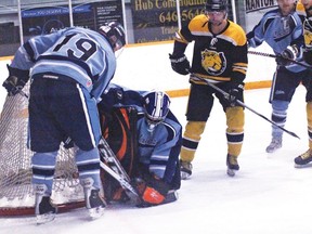 Lomond Laker goalie Danny Wilk covers the puck that Nanton Palomino Tyson Lowe tries to poke into the goal during a game at the Tom Hornecker Recreation Centre on March 8. The Pals ended up winning the best-of-five series in three games straight. 
Sheena Read QMI