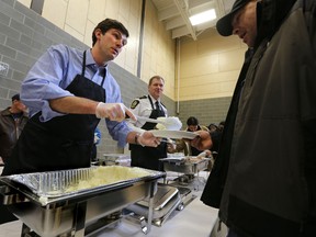 Mayor Don Iveson serves up some mashed potatoes at the Annual Inner City Roast Beef Dinner at the Boyle Street Plaza in Edmonton Alta., on Sunday March 16, 2014. Perry Mah/Edmonton Sun/QMI Agency