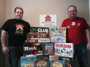 Meeples Cafe co-owners Paul Dueck (left) and Michael Penner show off some of the titles that will be available at Winnipeg's first board game cafe. (HANDOUT)