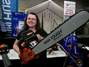 Tammy Dykens shows off the new Husqvarna chainsaw she won as part of an Edmonton Sun giveaway at the Boat and Sportsmen's Show Sunday.