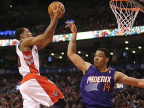 Raptors guard DeMar DeRozan (left) goes to the basket against the Suns’ Gerald Green and scores two of his 17 points at the Air Canada Centre yesterday. DeRozan had another tough shooting day, going 4-for-12 from the field. (Tom Szczerbowski/USA Today Sports)