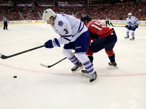 Maple Leafs' Dion Phaneuf and Nicklas Backstrom of the Capitals go after the puck yesterday in Washington. (AFP)