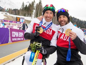Chris Klebl (left) and Brian McKeever show off their gold medals at the Sochi Paralympics, March 16, 2014. (MATTHEW MURNAGHAN/Canadian Paralympic Committee)