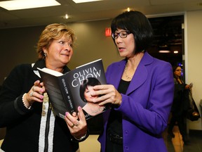 Sun columnist Sue-Ann Levy and Toronto mayoral candidate Olivia Chow take a look at the politician's book, My Journey. (STAN BEHAL, Toronto Sun)