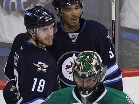 Winnipeg Jets forwards Evander Kane (top right) and Bryan Little celebrate Kane's goal past Dallas Stars goaltender Cristopher Nilstorp during NHL action at MTS Centre in Winnipeg, Man., on Sun., March 16, 2014. Kevin King/Winnipeg Sun/QMI Agency