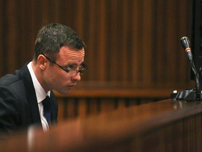 Olympic and Paralympic track star Oscar Pistorius takes notes as he sits in the dock during his trial for the murder of his girlfriend Reeva Steenkamp at the North Gauteng High Court in Pretoria, March 17, 2014. (REUTERS)