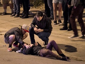 Bystanders tend to a man who was struck by a vehicle on Red River Street during the SXSW festival in downtown Austin.

REUTERS/Jay Janner