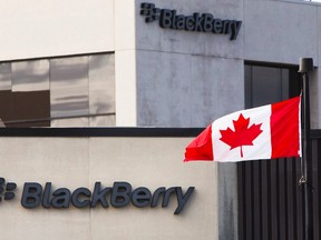 A Canadian flag waves in front of a Blackberry logo at the Blackberry campus in Waterloo, Ont., in this Sept. 23, 2013 file photo.   REUTERS/Mark Blinch/files