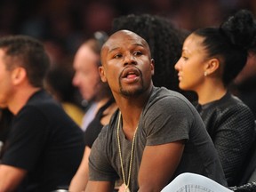 Boxer Floyd Mayweather Jr. attends the Los Angeles Lakers vs. Boston Celtics NBA game on February 21, 2014 at Staples Center. (AFP PHOTO/ROBYN BECK)