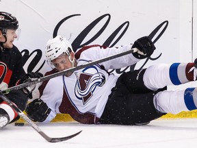 Ottawa Senators' Colin Greening crashes into the boards with Colorado Avalanches' Cory Sarich during NHL hockey action at the Canadian Tire Centre in Ottawa Sunday. Errol McGihon/Ottawa Sun