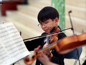 10 year old Keith Tam with the Music Enrichment Program performs at the annual Mayor's Celebration of the Arts nomination announcement at City Hall in Edmonton, Alberta on Monday, March 17, 2014.    Perry Mah/ Edmonton Sun/ QMI Agency