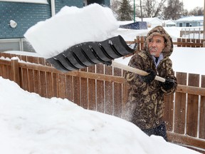 Hussain Ahmed shovels out his Burrows Avenue home in Winnipeg, Man. Monday March 17, 2014 following Sunday's snowfall.Brian Donogh/Winnipeg Sun/QMI Agency