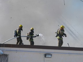 Chatham-Kent firefighters battle a fire on the Hillerich and Bradsby roof on Monday, March 17, 2014. Police said the fire is suspicious and is believed to have caused $70,000 worth of damage to the empty building.