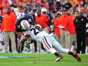 Sammie Coates #18 of the Auburn Tigers is tackled by Tray Matthews #28 of the Georgia Bulldogs at Jordan-Hare Stadium on November 16, 2013 in Auburn, Alabama. (Scott Cunningham/Getty Images/AFP)