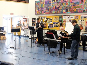 St. Thomas Aquinas students rehearse in their music room for the upcoming Beatlemania concert on March 26 and 27