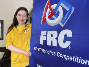 Team member Eden Bibic of Kingston, shows the banner the local WAFFLES robotics team brought home after winning a regional robotics competition in Oshawa recently. They are now off to the world championships. 
MICHAEL LEA\THE WHIG STANDARD\QMI AGENCY