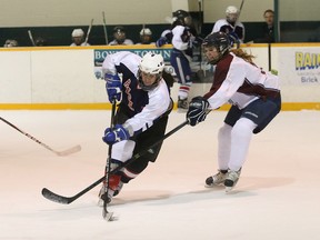 Serina Seguin, left, of Marymount Academy, skates past a St. Theresa Catholic Secondary School defender during girls OFSAA A/AA hockey action at Carmichael Arena in Sudbury on Tuesday.