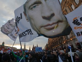 People attend a rally called "We are together" to support the annexation of Ukraine's Crimea to Russia in Red Square in central Moscow, March 18, 2014. REUTERS/Maxim Shemetov