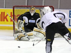 Goalie Matt Mahalak stops a shot from Samuel Schutt as the Kingston Frontenacs work out at the Rogers K-Rock Centre on Tuesday. They start their first-round playoff series against the Peterborough Petes on Friday. (Ian MacAlpine/The Whig-Standard)