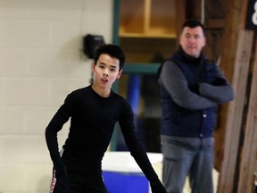 Coach Brian Orser keeps a close eye on world junior figure skating champion Nam Nguyen in Toronto yesterday. (Michael Peake/Toronto Sun)