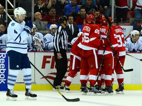 Red Wings players celebrate a goal in front of Maple Leafs defenceman Cody Franson on Tuesday night in Detroit. (Andrew Weber/USA TODAY)