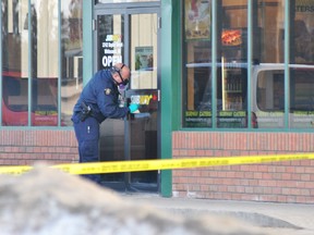 An RCMP forensics member dusts for prints after an early morning robbery at the Kepler Street Subway on Wednesday, March 19. Barry Kerton photo | Whitecourt Star