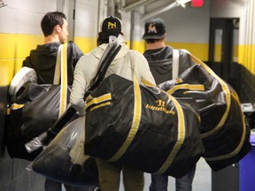 Sarnia Sting players Brodie Barrick (left), Nick Latta (centre), and Jimmy McDowell (right) walk out of the RBC Centre with their gear after completing exit interviews on Sunday, March 15. Barrick is eligible to return to the Sting as an overage player next year, while Latta and McDowell both concluded their OHL careers on Saturday, March 14 as the Sting fell 8-4 to the Erie Otters in the last game of the season. SHAUN BISSON/THE OBSERVER/QMI AGENCY