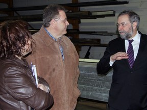 Jeff Tribe/Tillsonburg News
New Democratic Party and the Official Opposition Leader Tom Mulcair (right) shares a smile and discussion with Micki Tremblay (left) and Brad Martin (centre) of Martin Farms, Wednesday morning in Tillsonburg at the Erie Structures greenhouse plant. Mulcair stopped in for a tour and a discussion that revolved around jobs, sustainability and local food.