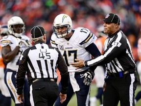 San Diego Chargers quarterback Philip Rivers (17) reacts to a penalty called by line judge Jeff Seeman (45) and referee Terry McAulay (77) in the third quarter during the 2013 AFC divisional playoff football game against Denver at Sports Authority Field at Mile High. (Ron Chenoy-USA TODAY Sports)