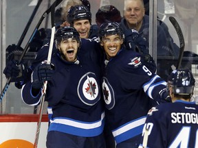 Winnipeg Jets forward Evander Kane (9) celebrates with teammates after scoring against the Colorado Avalanche during the second period at MTS Centre.  Bruce Fedyck-USA TODAY Sports