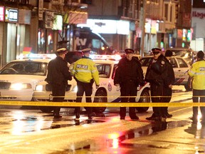 Toronto Police at the scene of a double shooting at Danforth and Cedarvale Aves., just east of Woodbine Ave., Wednesday, March19, 2014. (John Hanley photo)