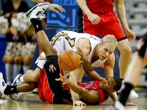 Raptors guard Kyle Lowry (bottom) battles for the ball with Pelicans centre Greg Stiemsma in New Orleans last night. (USA Today/photo)