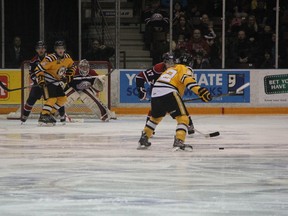 Jeff King winds up for a slapshot while Noah Bushnell attempts to set a screen during a Sarnia Sting vs Saginaw Spirit game this past season. SHAUN BISSON/THE OBSERVER/QMI AGENCY