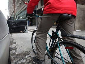 Under proposed new Ontario legislation introduced this week, fines for dooring — opening a car door into the path of an oncoming cyclist — could go up to as much as $1,000. Tony Caldwell/Ottawa Sun/QMI Agency