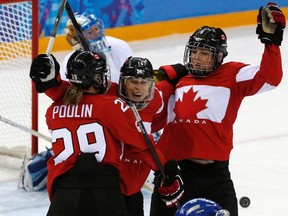 Canada's Jayna Hefford (C) celebrates her goal on Finland with teammates Marie-Philip Poulin and Rebecca Johnston (R) during the third period of their women's ice hockey game at the 2014 Sochi Winter Olympics.
Reuters/QMI Agency