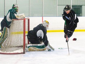 London Knights defenceman Nikita Zadorov leaps over goaltender Anthony Stolarz?s stick as Knights goaltender Jake Patterson looks on from behind the net during a practice at the Western Fair Sports Centre on Thursday. The Knights will open the first round of the OHL playoffs against the Windsor Spitfires at Budweiser Gardens on Fright night. (CRAIG GLOVER, The London Free Press )