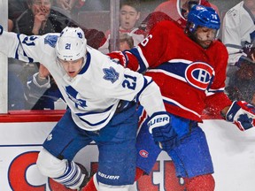 Leafs’ James van Riemsdyk and defenceman P.K. Subban of the Canadiens — clashing along the boards during a game beween the two teams earlier this season — have taken turns tugging their sweaters after goals as mocking gestures. (Martin Chevalier/QMI Agency)