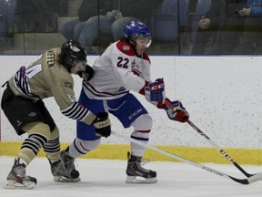 Kingston Voyageurs' Alex Tonge battles with Trenton Golden Hawks' Brady Wiffen to keep the puck in the Hawks' end during the first period of Game 5 of an OJHL North-East Conference semifinal playoff series at the Invista Centre on Thursday night. (Julia McKay/The  Whig-Standard)