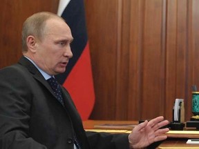 Russian President Vladimir Putin (L) speaks with Defence Minister Sergei Shoigu during a meeting in Moscow's Kremlin March 20, 2014. REUTERS/Alexei Druzhinin/RIA Novosti/Kremlin