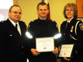 Deputy EMS chief Jeff Horseman and Huron County Warden Joe Steffler flank James Janssen and Tharon Riley, who received congratulatory certificates and a stork pin for helping deliver a baby at a residence in Ashfield-Colborne-Wawanosh in January.
