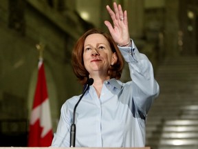 Alberta Premier Alison Redford waves to cheering supporters after announcing her resignation at the Alberta Legislature, in Edmonton Alta., on Wednesday March 19, 2014. (David Bloom/QMI Agency)