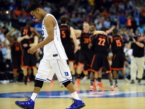 Duke Blue Devils guard Quinn Cook (2) walks off the court after losing to the Mercer Bears during the second round of the NCAA Tournament at PNC Arena. (Bob Donnan/USA TODAY Sports)