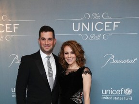 Actress Alyssa Milano and her husband Dave Bugliari pose at the UNICEF Ball fundraising gala in Beverly Hills, California January 14, 2014. (REUTERS/Mario Anzuoni)